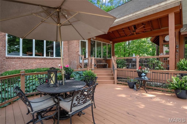 deck featuring outdoor dining space and ceiling fan