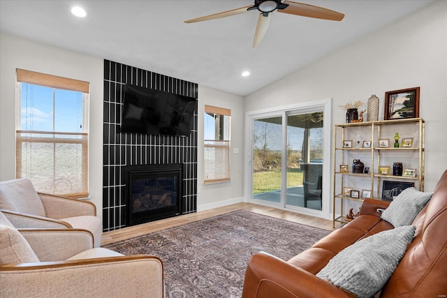 living room featuring a fireplace, lofted ceiling, recessed lighting, ceiling fan, and healthy amount of natural light