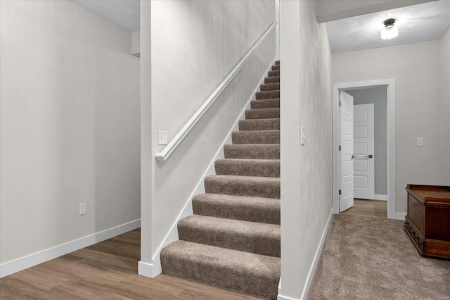 stairs with baseboards and wood finished floors