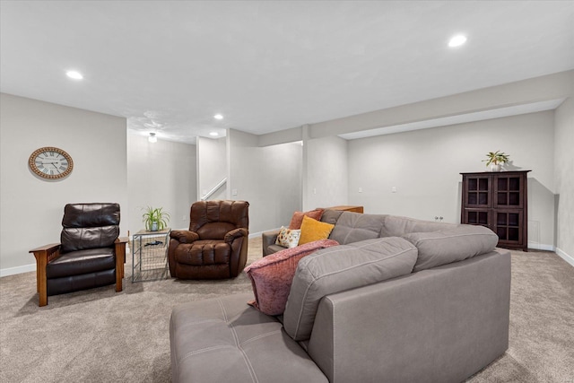 carpeted living area featuring recessed lighting, baseboards, and stairs