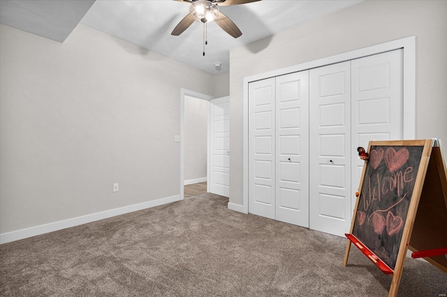 bedroom with carpet flooring, a closet, baseboards, and a ceiling fan