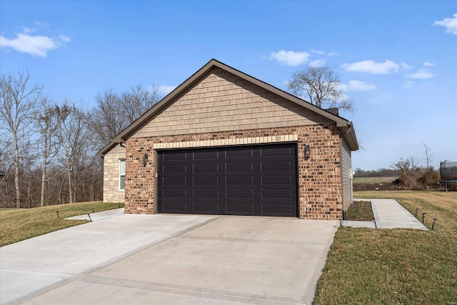 garage featuring concrete driveway