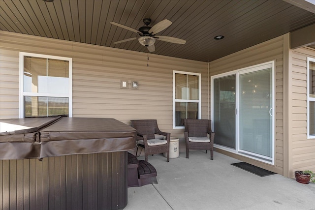 view of patio / terrace featuring a hot tub and ceiling fan