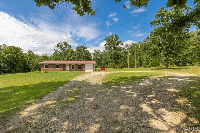 1575 County Road 3290, Salem, MO 65560 - view of front of house featuring dirt driveway, an attached garage, and a front lawn