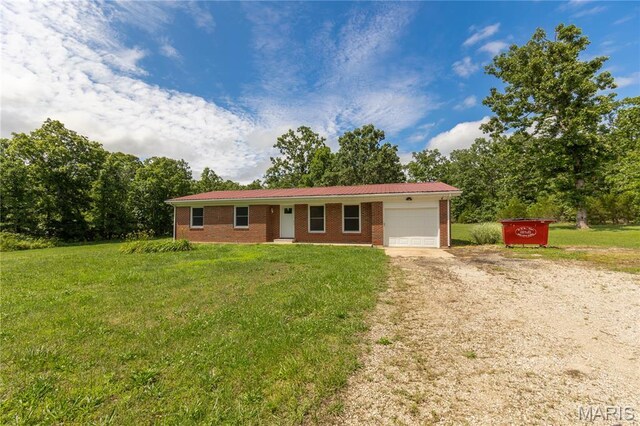 1575 County Road 3290, Salem, MO 65560 - ranch-style house with dirt driveway, a garage, brick siding, and a front yard