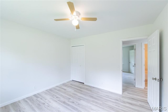 1575 County Road 3290, Salem, MO 65560 - unfurnished bedroom featuring light wood-style floors, baseboards, a closet, and a ceiling fan