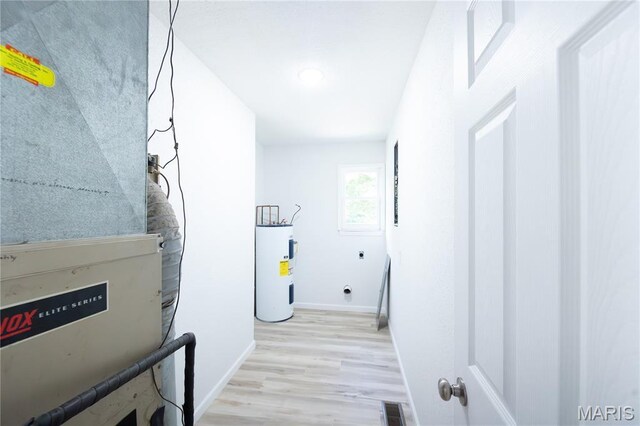 1575 County Road 3290, Salem, MO 65560 - hallway with water heater, baseboards, light wood-style flooring, heating unit, and recessed lighting