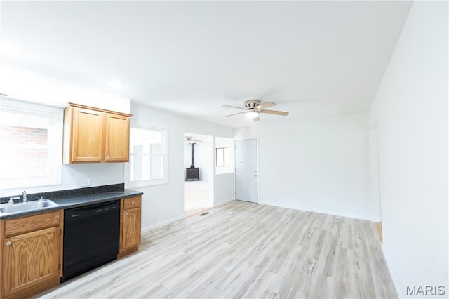 1575 County Road 3290, Salem, MO 65560 - kitchen with dishwasher, a sink, dark countertops, light wood-style floors, and a ceiling fan