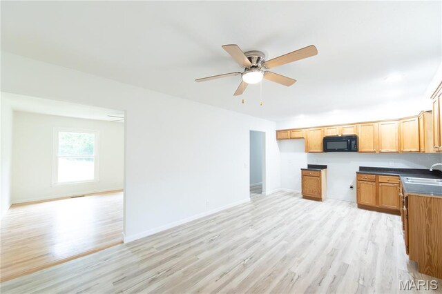 1575 County Road 3290, Salem, MO 65560 - kitchen featuring black microwave, a sink, light wood-style flooring, ceiling fan, and baseboards