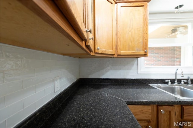 1575 County Road 3290, Salem, MO 65560 - kitchen view of a sink, dark countertops, baseboards, and brown cabinets