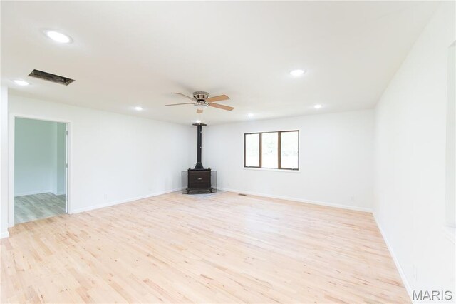 1575 County Road 3290, Salem, MO 65560 - empty room featuring a wood stove, light wood finished floors, recessed lighting, a ceiling fan, and baseboards