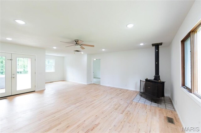 1575 County Road 3290, Salem, MO 65560 - unfurnished living room featuring light wood finished floors, recessed lighting, a ceiling fan, a wood stove, and baseboards