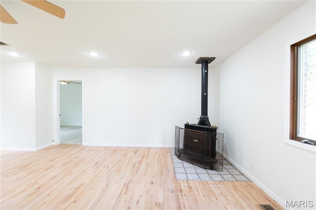 1575 County Road 3290, Salem, MO 65560 - detailed view of wood finished floors, ceiling fan, a wood stove, recessed lighting, and baseboards