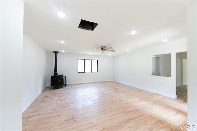 1575 County Road 3290, Salem, MO 65560 - unfurnished living room with a wood stove, light wood-type flooring, recessed lighting, ceiling fan, and baseboards