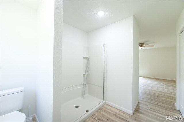 1575 County Road 3290, Salem, MO 65560 - bathroom featuring baseboards, wood finished floors, toilet, walk in shower, and ceiling fan