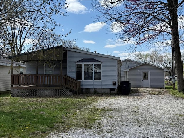 905 N Olive St, Saint Elmo, IL 62458 - back of property with crawl space, driveway, and a wooden deck