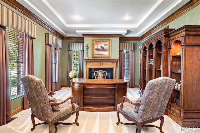 home office featuring a premium fireplace, plenty of natural light, a raised ceiling, ornamental molding, and baseboards