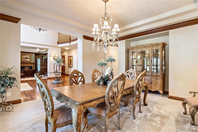 dining room featuring a chandelier and baseboards