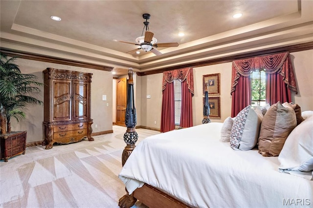 bedroom featuring a tray ceiling, light carpet, recessed lighting, baseboards, and ceiling fan