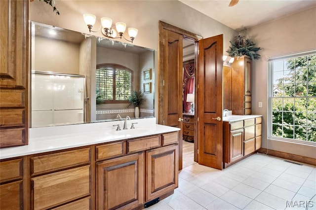 full bathroom with tile patterned floors, vanity, healthy amount of natural light, and baseboards