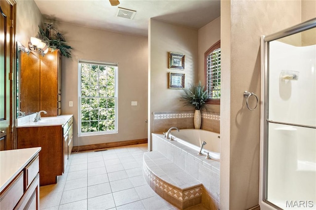 bathroom with vanity, a shower stall, tile patterned flooring, and a garden tub
