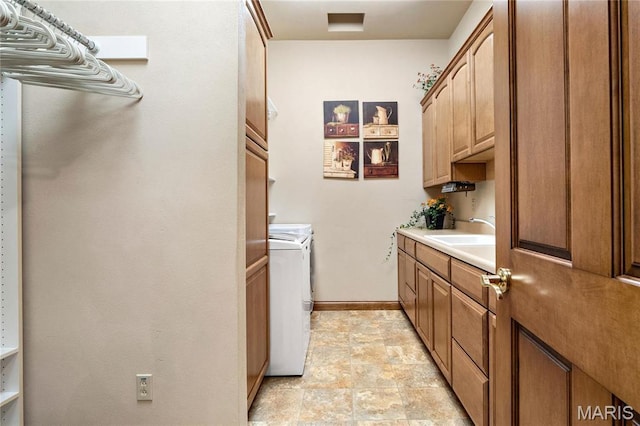 laundry room with washer and dryer, cabinet space, and baseboards