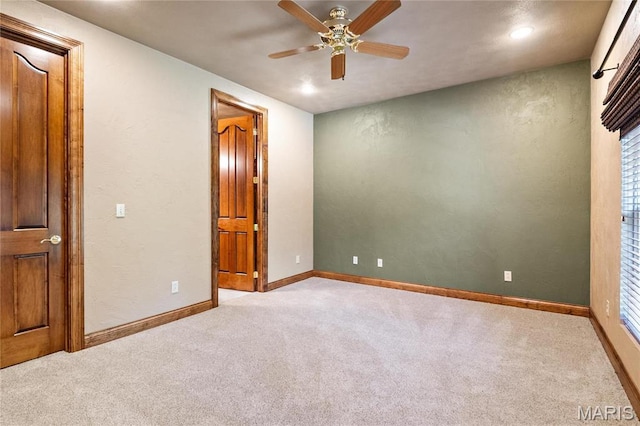 carpeted empty room with ceiling fan, baseboards, and recessed lighting
