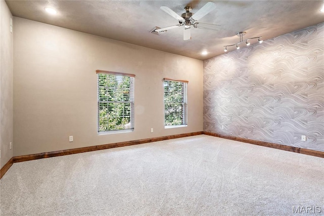 spare room with baseboards, carpet, wallpapered walls, a ceiling fan, and recessed lighting
