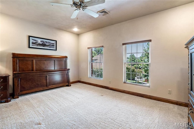empty room with light carpet, baseboards, and ceiling fan