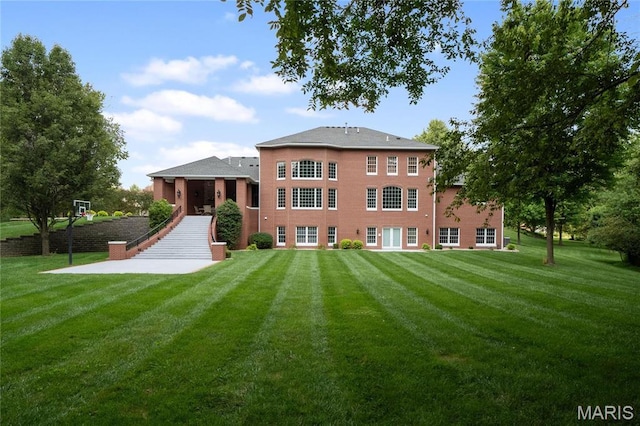 back of property featuring a yard