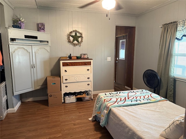 bedroom with wood finished floors, ceiling fan, and baseboards
