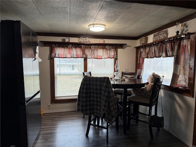 dining space featuring plenty of natural light, baseboards, and wood finished floors