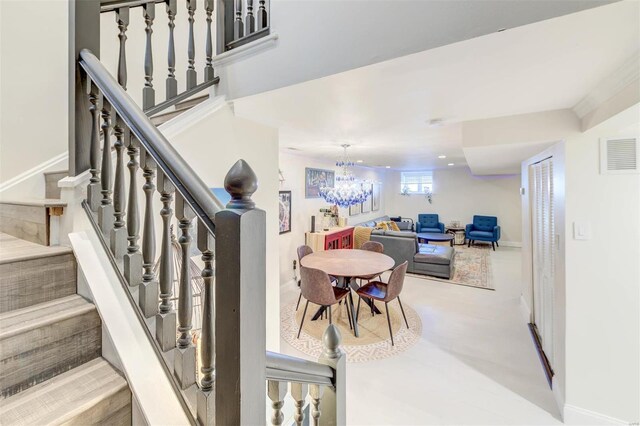 4561 Laclede Ave Unit B, Saint Louis, MO 63108 - stairs with a chandelier and baseboards