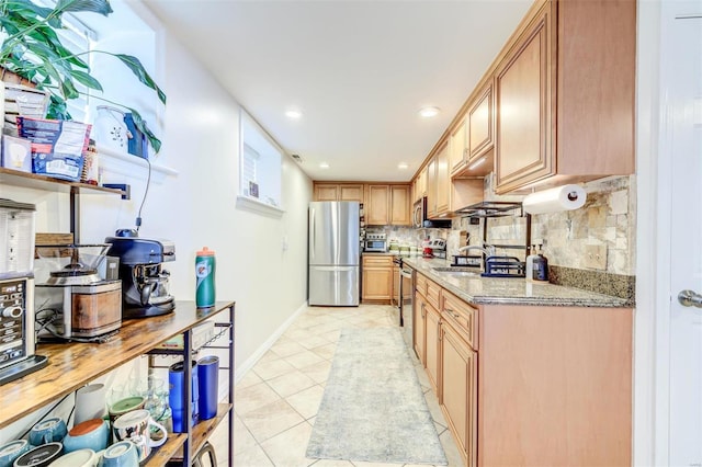 4561 Laclede Ave Unit B, Saint Louis, MO 63108 - kitchen with stainless steel appliances, tasteful backsplash, light tile patterned flooring, baseboards, and light stone counters