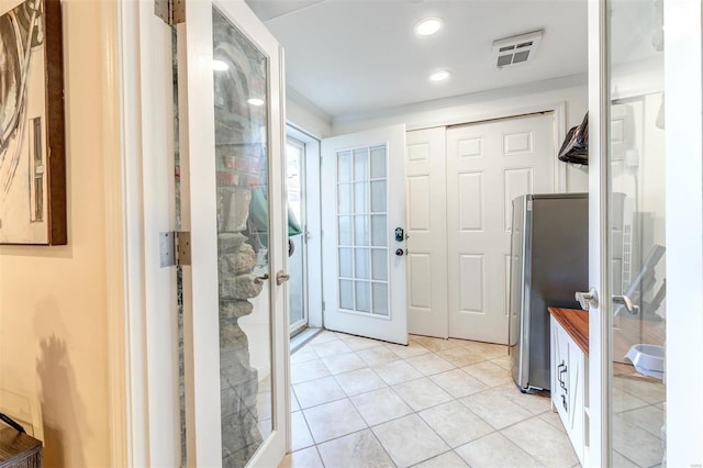 4561 Laclede Ave Unit B, Saint Louis, MO 63108 - foyer entrance with french doors and light tile patterned floors
