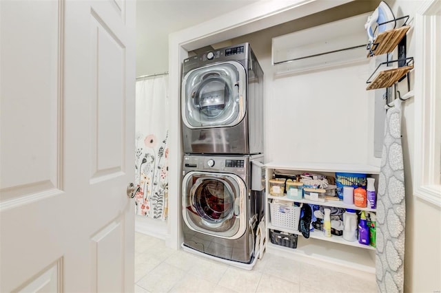 4561 Laclede Ave Unit B, Saint Louis, MO 63108 - laundry area with stacked washer / drying machine and tile patterned flooring