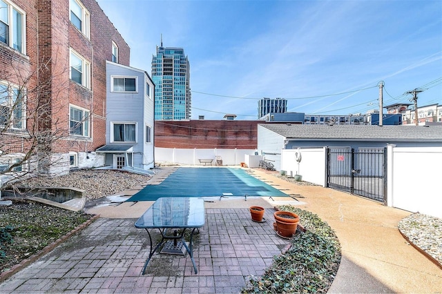4561 Laclede Ave Unit B, Saint Louis, MO 63108 - view of swimming pool featuring a fenced backyard and a patio area