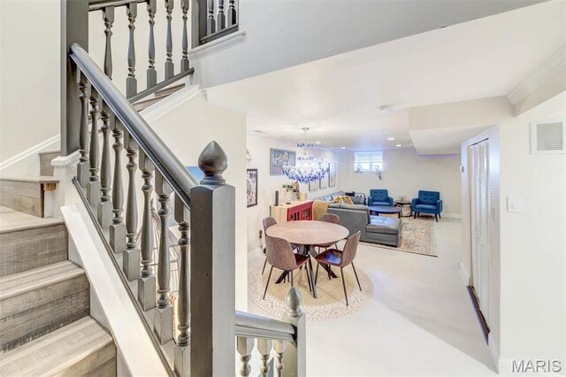 4561 Laclede Ave Unit B, Saint Louis, MO 63108 - stairway with a chandelier and baseboards