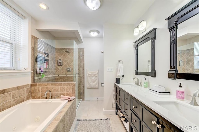 4561 Laclede Ave Unit B, Saint Louis, MO 63108 - full bathroom featuring a whirlpool tub, a stall shower, double vanity, tile patterned floors, and baseboards