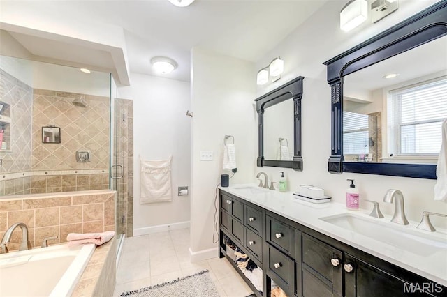 4561 Laclede Ave Unit B, Saint Louis, MO 63108 - full bathroom featuring double vanity, a garden tub, a shower stall, tile patterned flooring, and baseboards