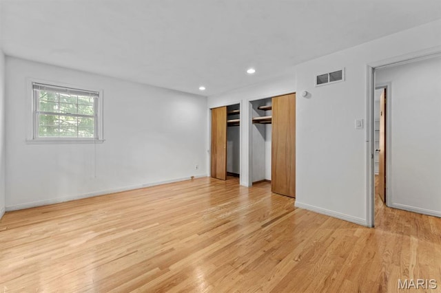 10267 Thornwood Dr, Ladue, MO 63124 - unfurnished bedroom with multiple closets, light wood-style flooring, baseboards, and recessed lighting