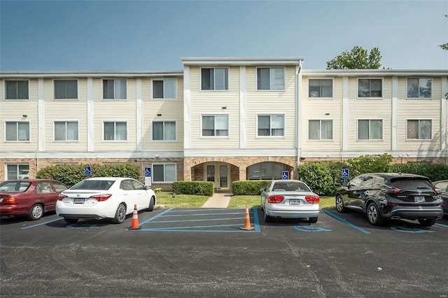 view of building exterior featuring uncovered parking