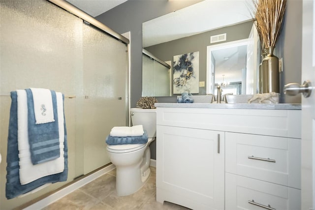 bathroom featuring a stall shower, vanity, toilet, and tile patterned floors