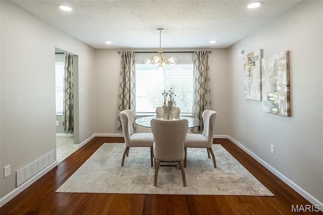 942 Guelbreth Ln Unit 112, Saint Louis, MO 63141 - dining space with a chandelier, wood finished floors, a textured ceiling, and recessed lighting
