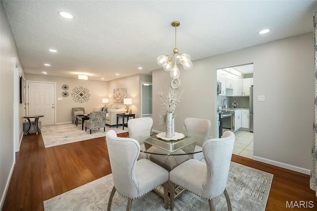 942 Guelbreth Ln Unit 112, Saint Louis, MO 63141 - dining area featuring light wood-style flooring, recessed lighting, and a textured ceiling