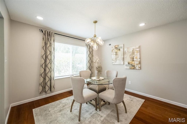 942 Guelbreth Ln Unit 112, Saint Louis, MO 63141 - dining room featuring wood finished floors, a chandelier, a textured ceiling, and recessed lighting
