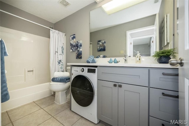 942 Guelbreth Ln Unit 112, Saint Louis, MO 63141 - bathroom with washer / dryer, tile patterned flooring, vanity, and shower / bath combo with shower curtain