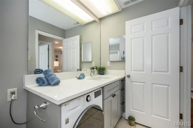 942 Guelbreth Ln Unit 112, Saint Louis, MO 63141 - laundry area featuring cabinet space, light tile patterned flooring, and washer / dryer
