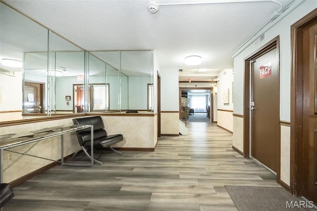 942 Guelbreth Ln Unit 112, Saint Louis, MO 63141 - corridor with wood finished floors and a textured ceiling