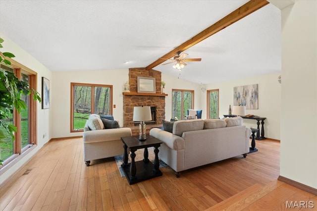 1346 Forest Splendor Trl, Wildwood, MO 63021 - living area featuring light wood-type flooring, ceiling fan, a stone fireplace, and baseboards